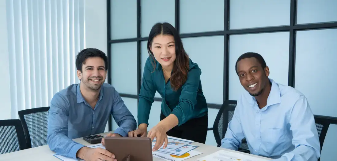 three-smiling-mix-raced-professionals-discussing-new-project-conference-table
